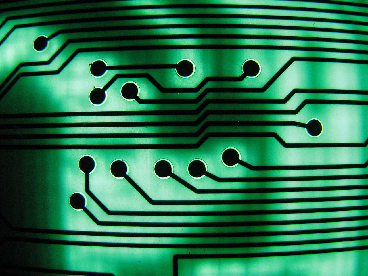 Macro view of a green circuit board showing traces and pads