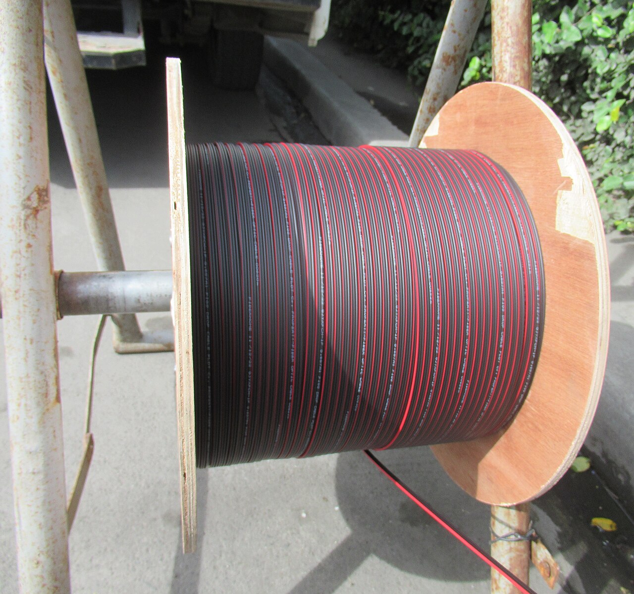 A large spool wound with bundles of optical fiber cable